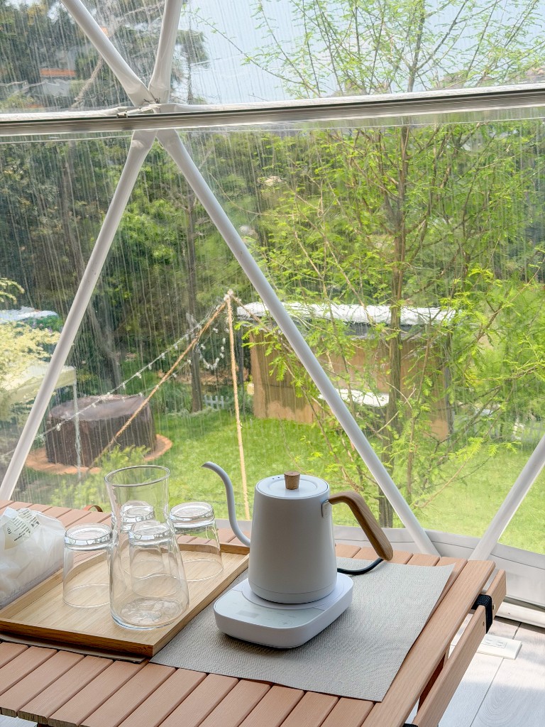 雲朵房帳內手沖咖啡壺、玻璃杯與木質托盤特寫，背景為森林透明球體窗，桃園楊梅森林豪華露營｜揪好森