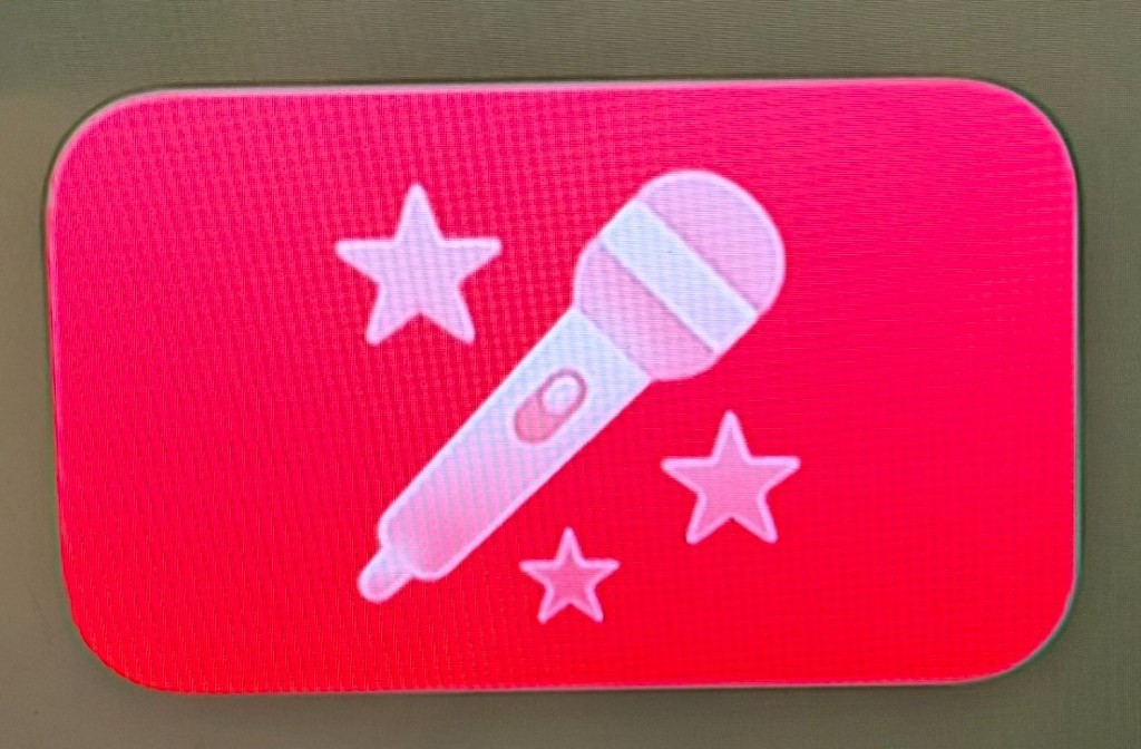 Apple Music 唱歌 App 圖示特寫，粉紅底白色麥克風與星星